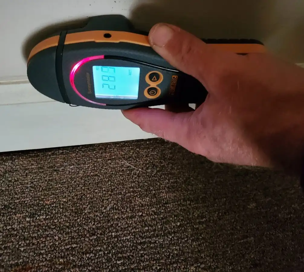 Moisture detection at baseboard during Storm Damage Restoration in Hollis